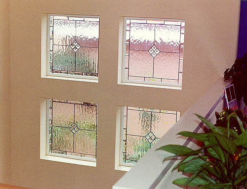 The beveled borders surrounding these 200 Series windows creates dramatic effects to this stairwell